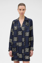 Profile view of model wearing the Oroton Marine Fish Tunic Dress in NORTH SEA and 100% lightweight, fluid silk twill fabric with a fine weave for Women .
