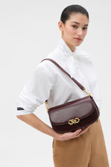 Profile view of model wearing the Oroton Olivia Day Bag in COPPER and Premium crackle leather for Women .