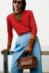 Profile view of model wearing the Oroton Mica Suede Bowler in Teak and Premium suede leather for Women .