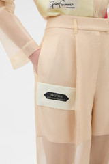 Profile view of model wearing the Oroton Patched Vintage Label Pyjama Pant in Nougat and 100% sheer silk organdy fabric for Women .