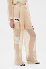 Profile view of model wearing the Oroton Patched Vintage Label Pyjama Pant in Nougat and 100% sheer silk organdy fabric for Women .