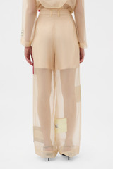 Profile view of model wearing the Oroton Patched Vintage Label Pyjama Pant in Nougat and 100% sheer silk organdy fabric for Women .