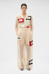 Profile view of model wearing the Oroton Patched Vintage Label Pyjama Pant in Nougat and 100% sheer silk organdy fabric for Women .
