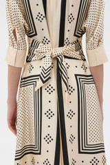 Profile view of model wearing the Oroton Spot Scarf Print Dress in Nougat and 100% silk twill fabric for Women .