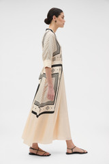 Profile view of model wearing the Oroton Spot Scarf Print Dress in Nougat and 100% silk twill fabric for Women .