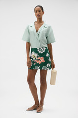 Profile view of model wearing the Oroton Short Sleeve Wrap Shirt in Glass and 100% silk dupion fabric for Women .