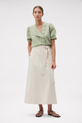 Profile view of model wearing the Oroton Snap Detail Skirt in Calico and 100% cotton fabric for Women .