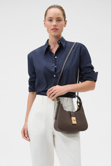Profile view of model wearing the Oroton Yvonne Baguette in Coffee Bean and Premium pebble leather for Women .