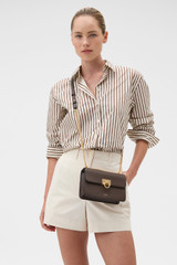 Profile view of model wearing the Oroton Yvette Small Clutch Bag in Coffee Bean and Premium textured leather for Women . IP:3