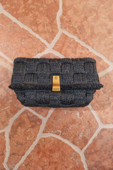 Detail product shot of the Oroton Etta Texture Medium Clutch in Dark Chocolate and Woven straw material for Women .