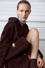 Profile view of model wearing the Oroton Mille Suede Baguette in Dark Chocolate and Premium suede leather for Women .