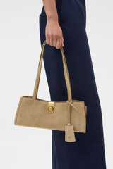 Profile view of model wearing the Oroton Mille Suede Baguette in Caper and Premium suede leather for Women .
