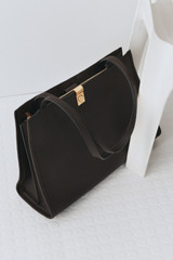 Profile view of model wearing the Oroton Mille Work Tote in Dark Chocolate and Premium pebble leather for Women .