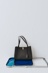 Profile view of model wearing the Oroton Mille Work Tote in Dark Chocolate and Premium pebble leather for Women .