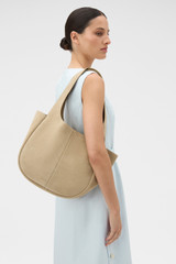 Profile view of model wearing the Oroton Emilia Suede Tote in Caper and Premium suede leather for Women .