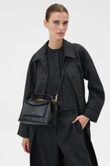 Profile view of model wearing the Oroton Mica Texture Bowler in Black Snake and Premium textured leather for Women .