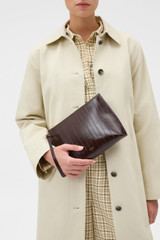Profile view of model wearing the Oroton Cecile Texture Pouch in Mulberry and Textured leather Outer for Women .