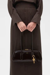 Profile view of model wearing the Oroton Louisa Crackle Shoulder Bag in Dark Chocolate and Premium smooth leather for Women .