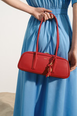 Profile view of model wearing the Oroton Louisa Shoulder Bag in Rouge and Premium smooth leather for Women .