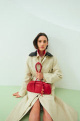 Profile view of model wearing the Oroton Louisa Shoulder Bag in Rouge and Premium smooth leather for Women .