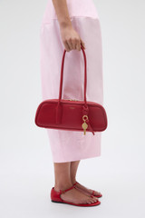 Profile view of model wearing the Oroton Louisa Shoulder Bag in Rouge and Premium smooth leather for Women .