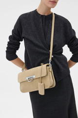 Profile view of model wearing the Oroton Finn Suede Large Day Bag in Caper and Premium suede leather for Women .