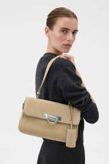 Profile view of model wearing the Oroton Finn Suede Large Day Bag in Caper and Premium suede leather for Women .
