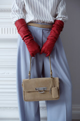 Profile view of model wearing the Oroton Finn Suede Large Day Bag in Caper and Premium suede leather for Women .