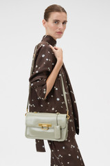 Profile view of model wearing the Oroton Finn Crackle Large Day Bag in Pistachio and Premium smooth leather for Women .