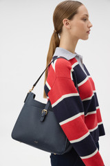 Profile view of model wearing the Oroton Dylan Large Bucket in Dark Navy and Premium pebble leather for Women .