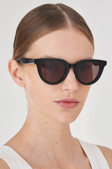 Profile view of model wearing the Oroton Heidi Sunglasses in Black and Premium acetate material for Women .