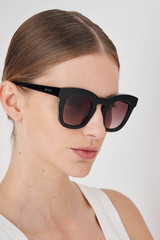 Profile view of model wearing the Oroton Duo Sunglasses in Black and Premium acetate material for Women .