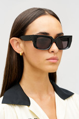 Profile view of model wearing the Oroton Spencer Sunglasses in Black and Acetate material for Women .