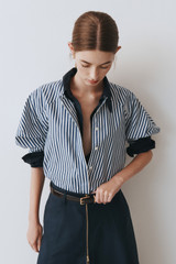 Profile view of model wearing the Oroton Sleeve Detail Stripe Shirt in North Sea/White and 100% cotton fabric for Women .