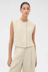 Profile view of model wearing the Oroton Button Detail Vest in Almond Creme and 72% Viscose, 28% linen for Women .
