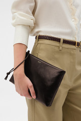 Profile view of model wearing the Oroton Marais Crackle Wristlet Pouch in Dark Chocolate and Premium smooth leather for Women .