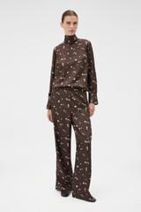 Profile view of model wearing the Oroton Mini Daisy Pyjama Pant in Milk Chocolate and 100% silk twill fabric for Women .