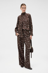 Profile view of model wearing the Oroton Mini Daisy Pyjama Pant in Milk Chocolate and 100% silk twill fabric for Women .