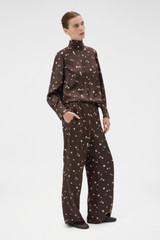 Profile view of model wearing the Oroton Mini Daisy Pyjama Pant in Milk Chocolate and 100% silk twill fabric for Women .