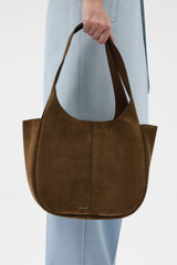 Profile view of model wearing the Oroton Emilia Suede Tote in Husk Brown and Premium cow suede leather for Women .