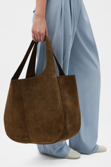Profile view of model wearing the Oroton Emilia Suede Large Tote in Husk Brown and Premium cow suede leather for Women .