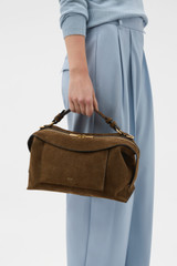 Profile view of model wearing the Oroton Mica Suede Large Bowler in Husk Brown and Premium cow suede leather for Women .