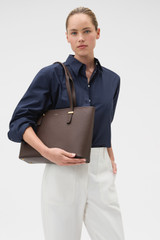 Profile view of model wearing the Oroton Anika 13" Tote & Cover in Coffee Bean and Premium pebble leather for Women .