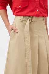Profile view of model wearing the Oroton Pleat Detail Midi Skirt in Sable and 100% cotton fabric for Women .