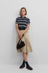 Profile view of model wearing the Oroton Pleat Detail Midi Skirt in Sable and 100% cotton fabric for Women .