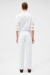 Profile view of model wearing the Oroton White Twill Pant in White and 100% cotton fabric for Women .