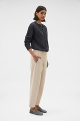 Profile view of model wearing the Oroton Fine Corduroy Pant in Eggshell and 97% cotton and 3% spandex blend fabric for Women .