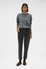 Profile view of model wearing the Oroton Fine Corduroy Pant in Washed Black and 97% cotton and 3% spandex blend fabric for Women .