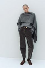 Profile view of model wearing the Oroton Fine Corduroy Pant in Washed Black and 97% cotton and 3% spandex blend fabric for Women .