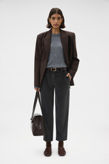 Profile view of model wearing the Oroton Fine Corduroy Pant in Washed Black and 97% cotton and 3% spandex blend fabric for Women .